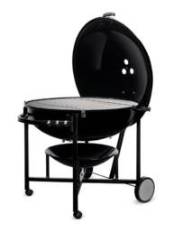 The enormous capacity of the Ranch Kettle charcoal barbecue sets the tone for a party that lasts until tomorrow.